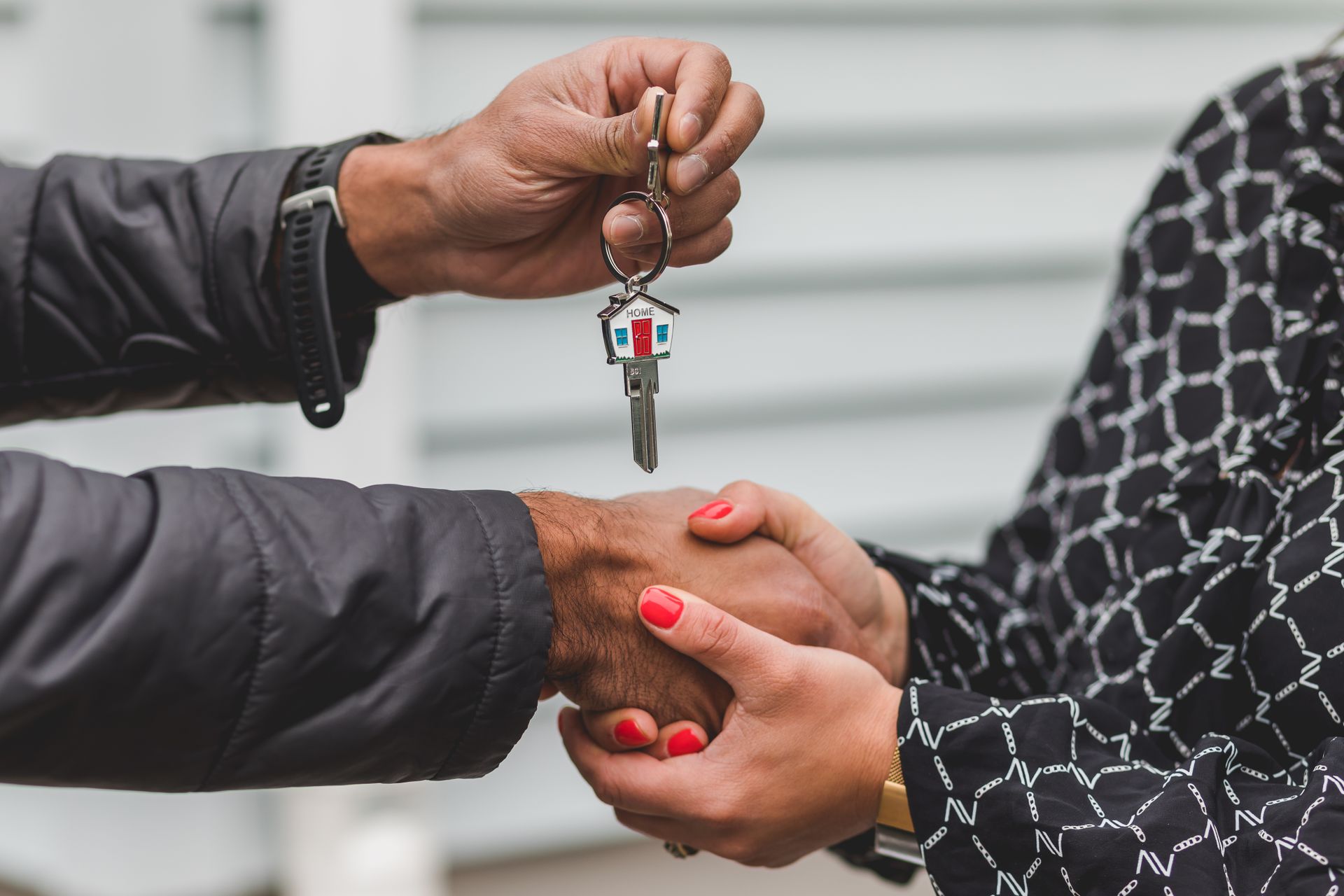 Homeowner receiving keys for home insurance protection